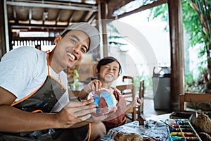 Painting ceramic pot in pottery workshop