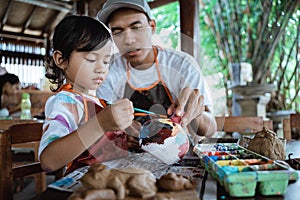 Painting ceramic pot in pottery workshop