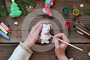 Painting Christmas toys from porcelain for decorations. Making clay toy with your own hands. Children& x27;s DIY concept. Handmade