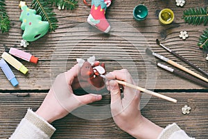 Painting Christmas toys from porcelain for decorations. Making clay toy with your own hands. Children& x27;s DIY concept. Handmade