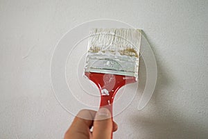 Painting a door or wall with a paintbrush. Oil-based paint