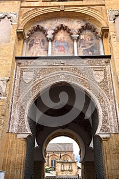 Painting the facade of the door of the el Perdon, Moorish facade of the Great Mosque in Cordoba, Andalusia, Spain photo