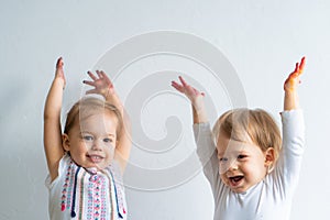 Painting is fun for kids - happy children play with dirty hands. Brother and sister playing with hands in the colorful