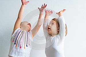 Painting is fun for kids - happy children play with dirty hands. Brother and sister playing with hands in the colorful