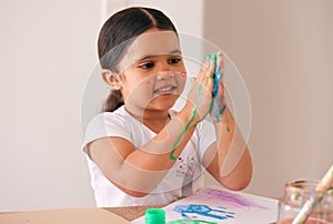 Painting hands, mess and happy child with art, home and learning creative expression at kindergarten. Education, color