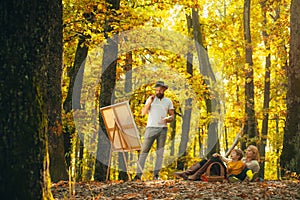 Painting in nature. Start new picture. Capture moment. Beauty of nature. Bearded man woman and son relax autumn nature