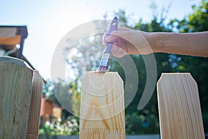 Painting new wooden fence with a transparent protective varnish