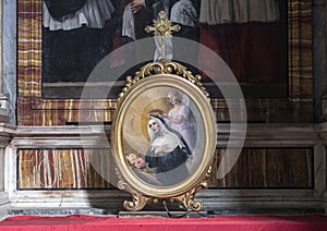 Painting in oval frame of an angel crowning the Blessed Virgin on an altar in San Lorenzo of Lucina, Rome, Italy