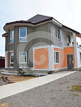 Painting and Plastering Exterior Stucco House Wall. Facade Thermal Insulation and Painting Works During Exterior Home Repair