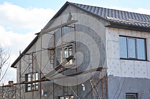 Painting, Plastering, Stucco and insulate Exterior House Wall. Facade Thermal Insulation and Painting Repair Works