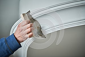 Painting and plasterwork. worker hand with spatula making molding