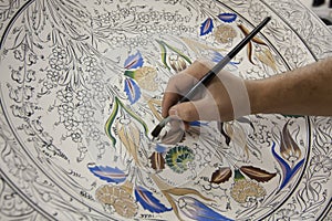 Painting of porcelain by hand. A traditional iznik