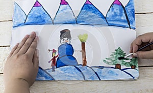 Painting with snowman and a Christmas tree, brush, paint. Process create new year painting