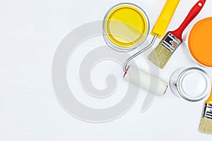Painting tools for house renovation on white wooden background