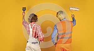 Painting wall. new house construction concept. Portrait of family wearing hardhat. Construction worker in protective