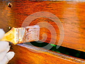 painting a wooden fence - a brush close-up, a very shallow depth