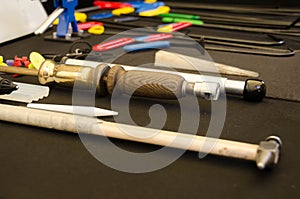 Paintless Dent Repair Kit Tools Set On The Work Table. Tools For Repair Dents On Car Body. Glue tabs With Slide Hammer.