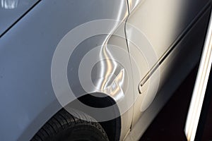 Paintless dent on white car