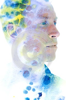 Paintography. Double exposure profile portrait of an attractive male model combined with hand drawn blue green and yellow