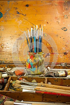 Paints and brushes art supplies in painting studio