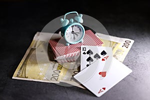 A pair of aces on a deck of playing cards with euro banknotes on a table. Online gambling.