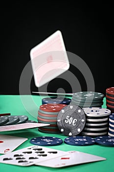 A pair of aces on a deck of playing cards. Poker playing chips on a green table. Online gambling. Addiction. Playing cards