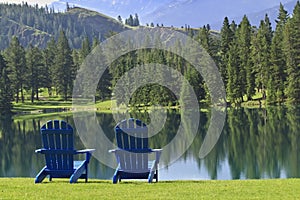 Pair of Adirondack chairs overlooking Beaufort Lake near Jasper, Canada