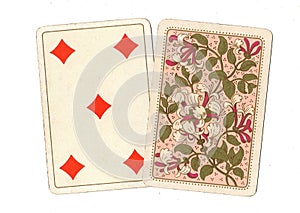 A pair of antique playing cards with the five of diamonds revealed.