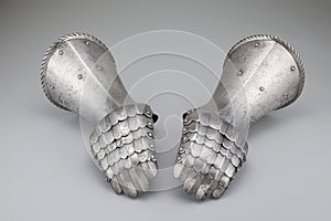 Pair of antique rusty gauntlets on a white background