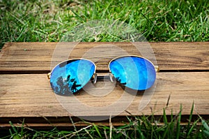A pair of aviator sunglasses on green grass