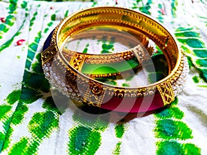 Pair of bangles incorporated with pink and green stones