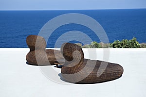 A pair of beach chairs and whiskey barrel table provide the perf