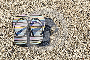 Pair of beach sandals lying on a beach