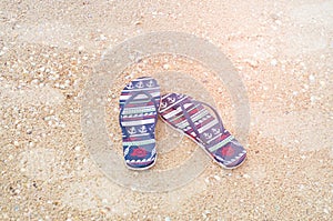 Pair of beach sandals on the sand