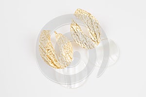 Pair of beautiful gold earrings with pendants made of nacre isolated on white