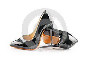 A pair of black classic women`s high-heeled shoes on white background