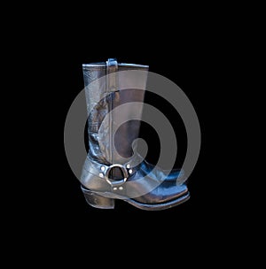 A pair of black cowboy boots isolated on a black background