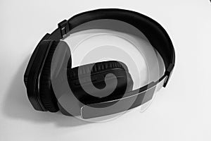 A pair of black on-ear wireless headphones on white background
