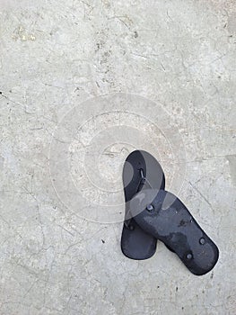 a pair of black flip flop sandal