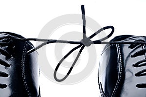 A pair of black shoes tied together