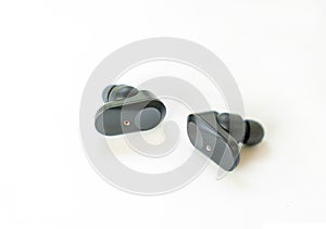 Pair of black true wireless earbuds isolate on white badckground
