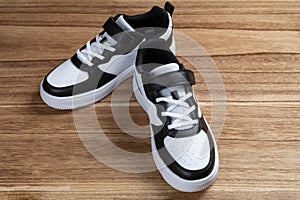 a pair of black and white sporty shoes for kid
