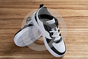 a pair of black and white sporty shoes for kid