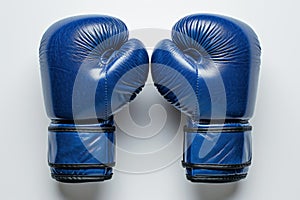 Pair of blue boxing gloves isolated on white background. Concept of boxing equipment, combat sports gear, training