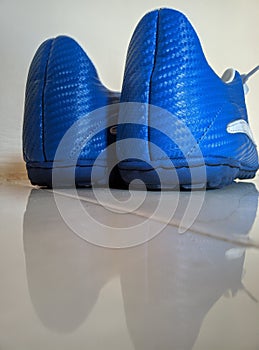 A pair of blue football shoes