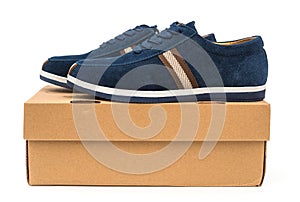 Pair of blue leisure shoes for man on a box on white