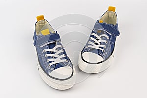 a pair of blue sneakers on a white background. Fashionable youth shoes