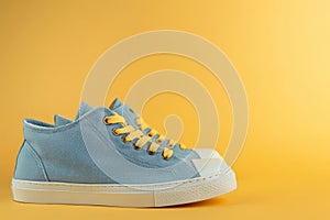 Pair of blue sneakers with yellow laces, pair of blue sneakers with yellow laces