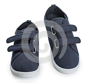 Pair of blue sporty sneakers, gumshoes for boy isolated on a white background, close up
