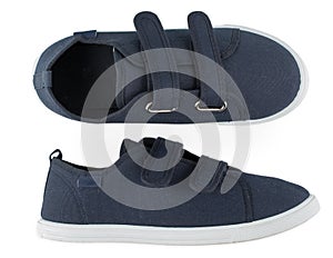 Pair of blue sporty sneakers, gumshoes for boy isolated on a white background, close up, top view
